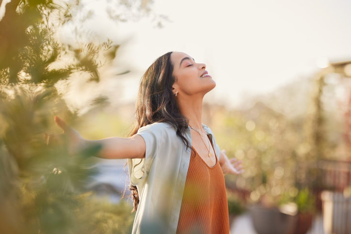 Vitality at GLO Calgary Functional medicine woman outside with arms out